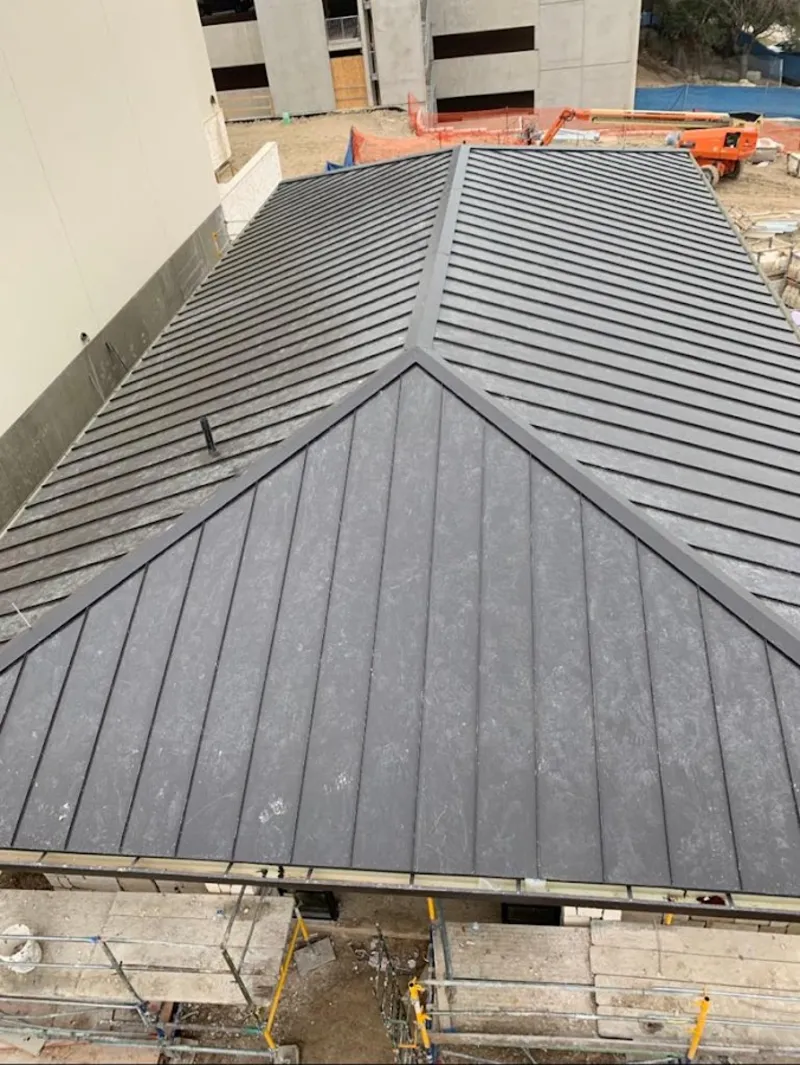 Commercial metal roof construction with crane equipment in Tamiami