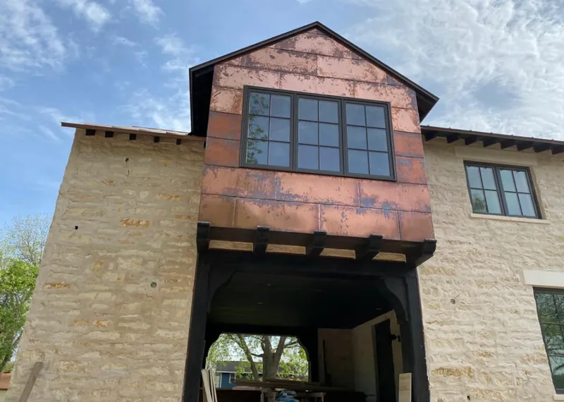 Copper metal panel facade on a stone building for Roof Repair in Tamiami